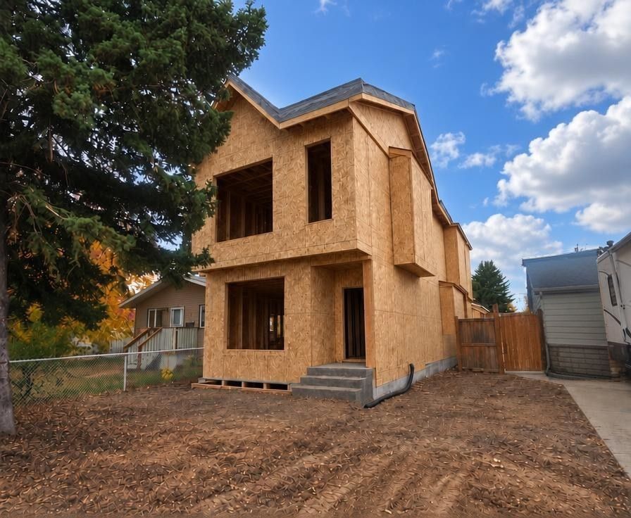 Visualization of the finished home shown at the sheathing and roofing stage, walls covered in board sheathing with roof underlayment installed